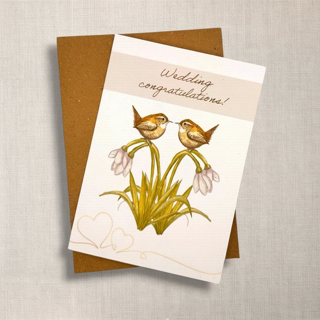 Wedding congratulations card with two British wren birds and snowdrop flowers, and brown Kraft envelope 