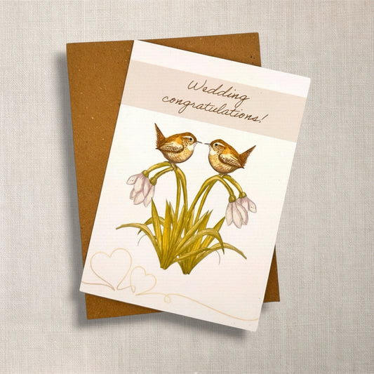 Wedding congratulations card with two British wren birds and snowdrop flowers, and brown Kraft envelope 
