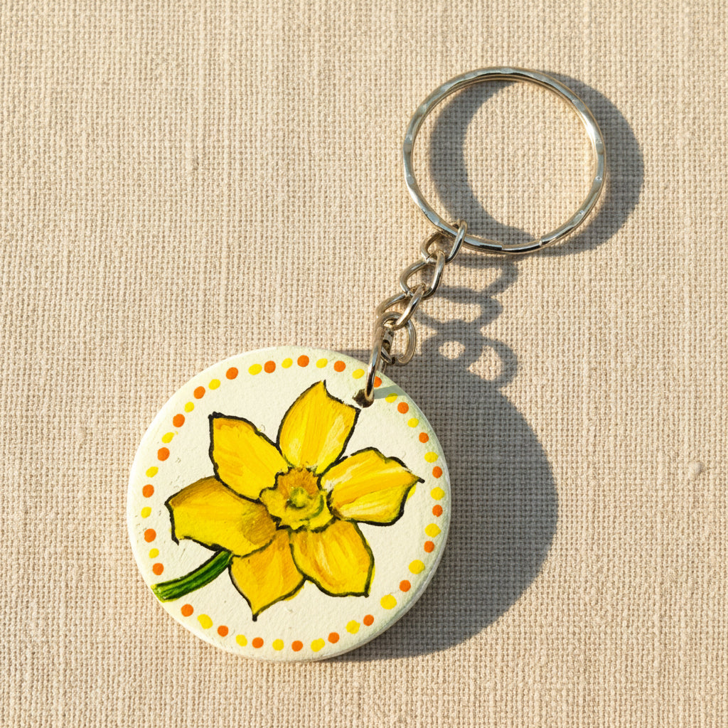 Keychain with a yellow daffodil flower design on a white background