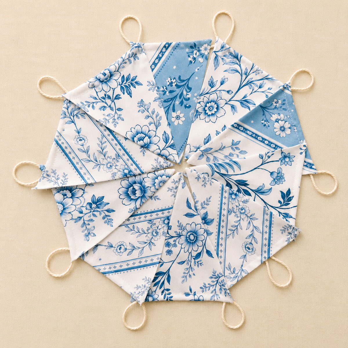 Handmade blue and white floral fabric bunting with 10 patterned flags and natural cotton twine