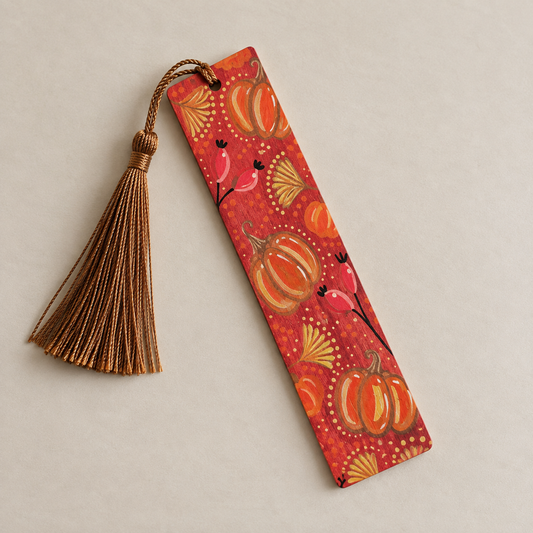 Hand-painted wooden autumn bookmark decorated with colourful pumpkins and botanical details, finished with a brown tassel.