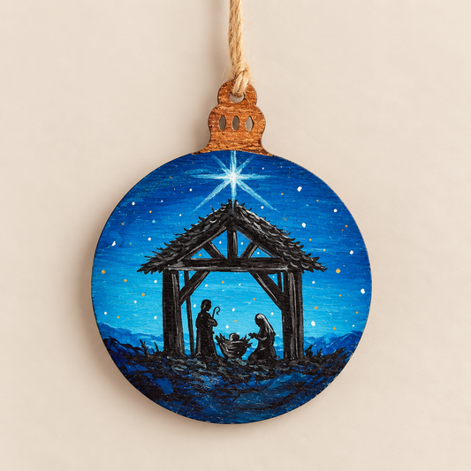 Hand painted wooden Christmas ornament featuring a nativity scene under a starry blue night sky.