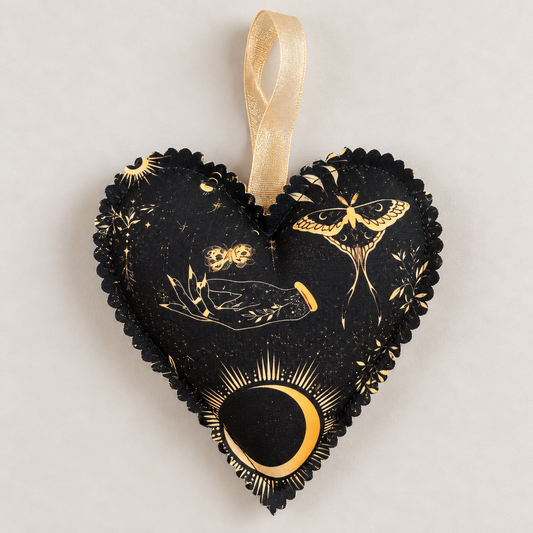 Handmade black fabric heart hanging decoration with gold moon, moth, botanical and celestial designs, finished with a sheer gold ribbon