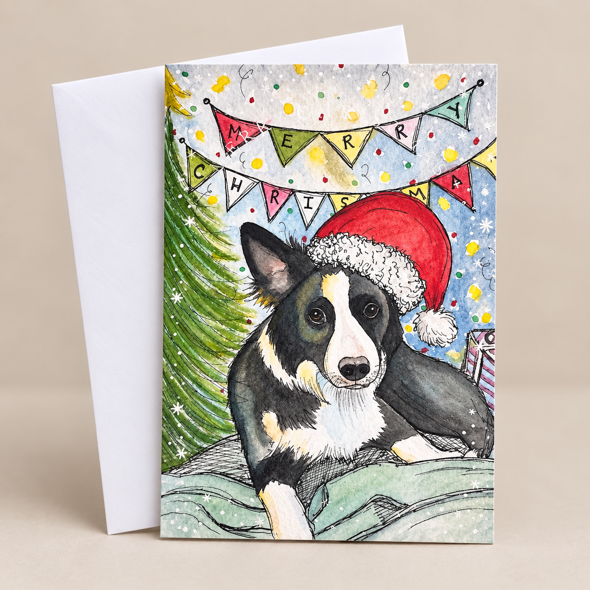 Festive Christmas card featuring a black and white border collie dog wearing a red Santa hat, beside a Christmas tree and colourful bunting, with a white envelope