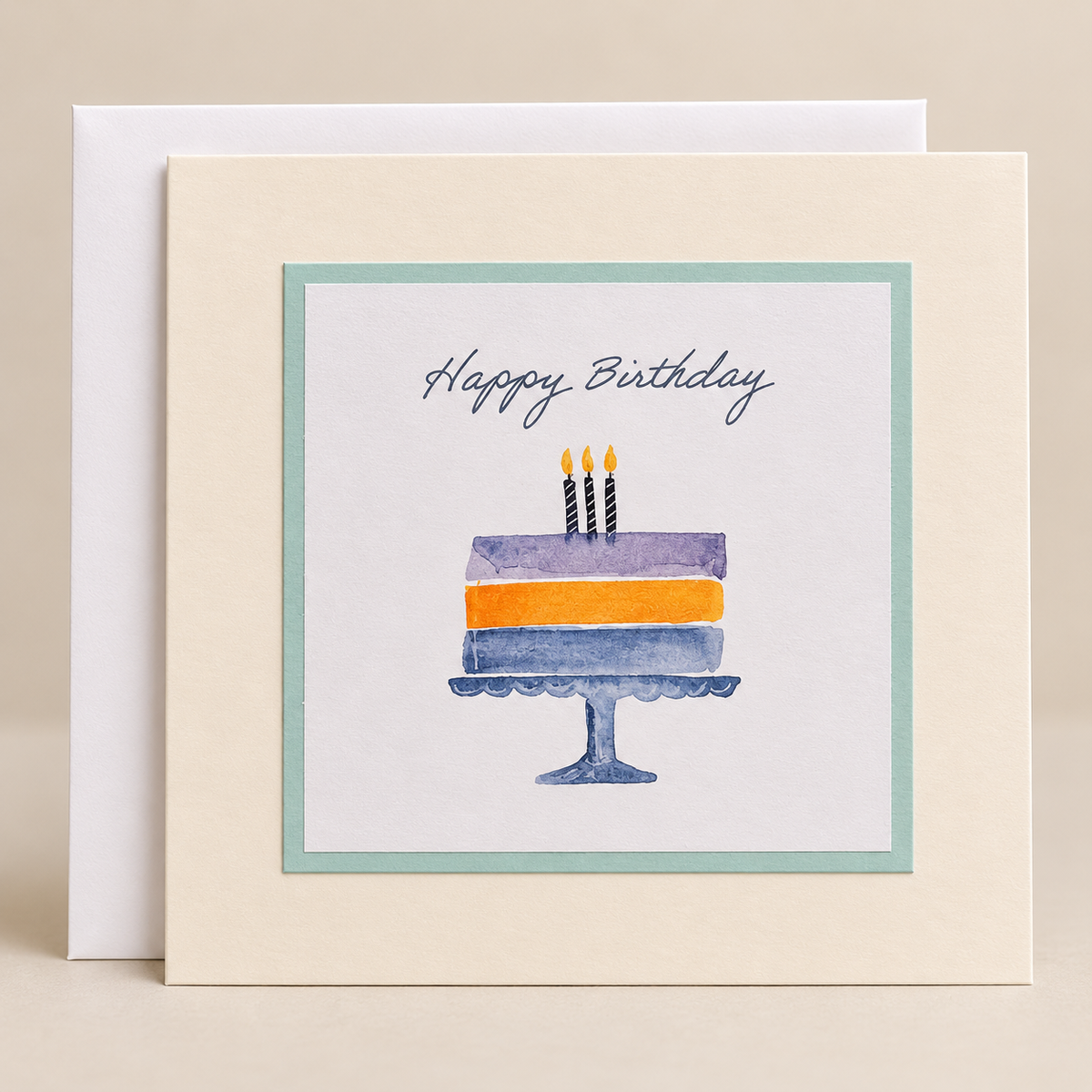 15 x 15 cm cream birthday card featuring a pastel watercolour cake illustration and Happy Birthday lettering, with a white envelope