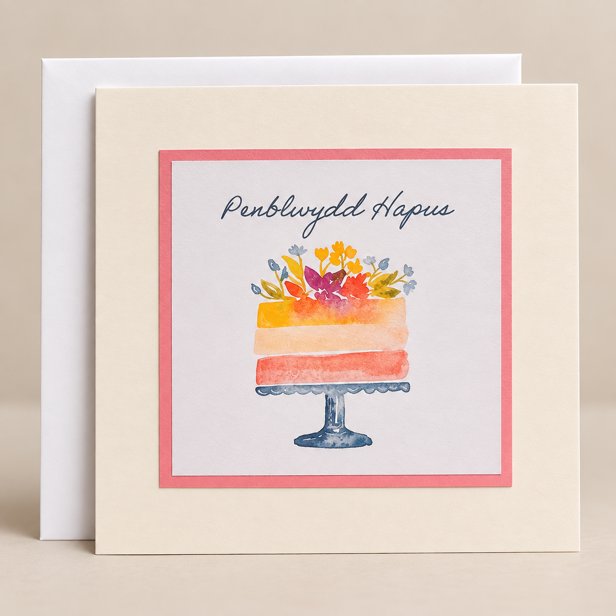 15 x 15 cm off-white Welsh birthday card featuring a colourful watercolour cake decorated with flowers and the words Penblwydd Hapus, with a white envelope